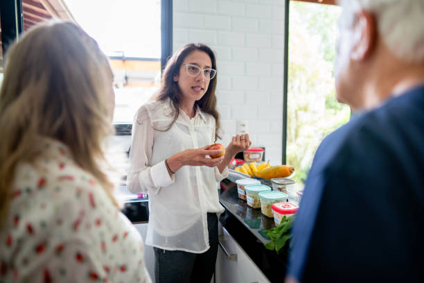 nutritionist organizing meal plans for a senior couple during a diet consultation - food stock pictures, royalty-free photos & images