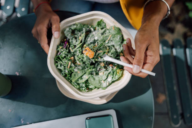 office worker having take out healthy salad bowl for lunch break enjoying a beautiful weather - junk food stock pictures, royalty-free photos & images