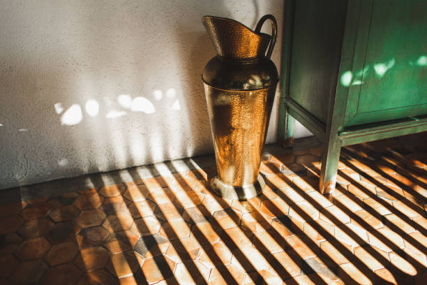 old vintage bronze vase in beautiful sun light. house decoration - home decoration stockfoto's en -beelden