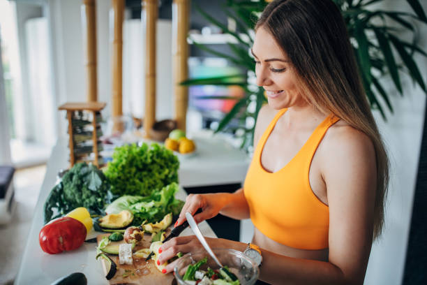 one fit woman making healthy vegetable salad for breakfast - food stock pictures, royalty-free photos & images
