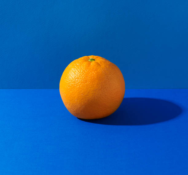 orange on blue background - food stock pictures, royalty-free photos & images