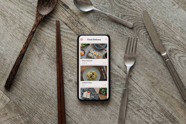 ordering food by mobile app delivery on smartphone - junk food stock pictures, royalty-free photos & images