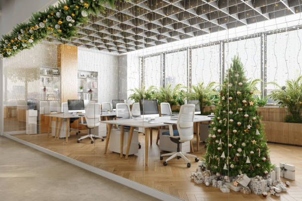 outside view of eco-friendly open plan modern office with christmas tree, ornaments, gift boxes, tables, office chairs and plants - home decoration stock pictures, royalty-free photos & images