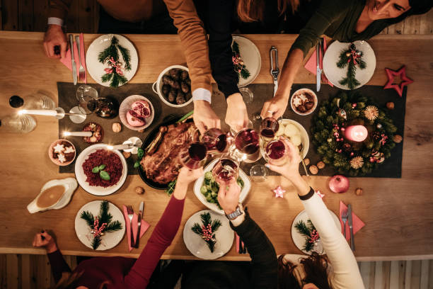 overhead view of friends eating traditional christmas meal - food stock pictures, royalty-free photos & images