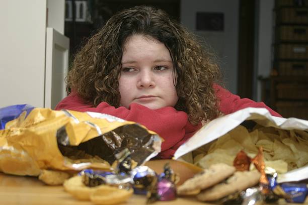 overweight child with junk food - junk food stock pictures, royalty-free photos & images