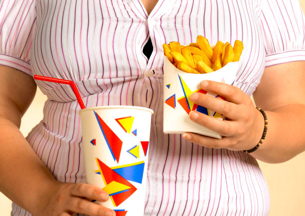 overweight woman with take out fast food - junk food stock pictures, royalty-free photos & images