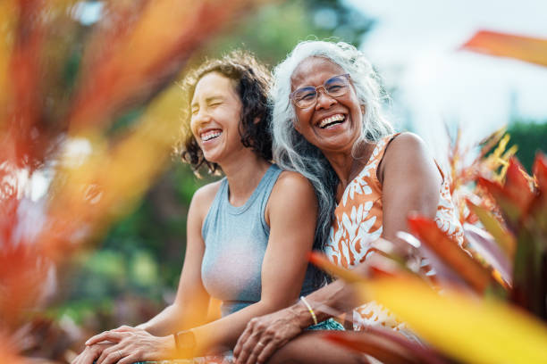pacific islander woman and eurasian adult daughter spending time together outdoors - travel stock pictures, royalty-free photos & images