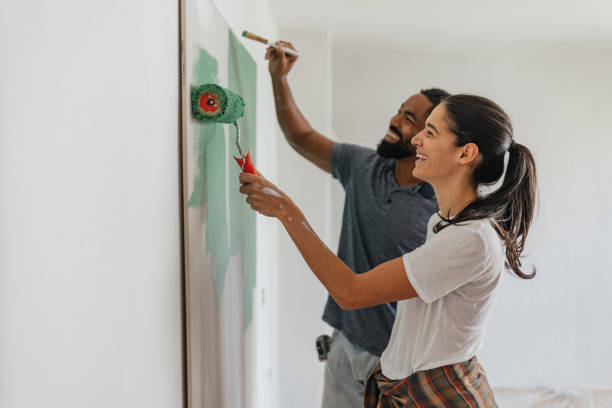 painting a wall together: love and collaboration - home decoration stock pictures, royalty-free photos & images