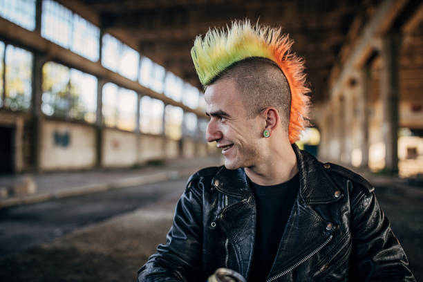 panker with colorful coiffure sitting in abandoned warehouse and drinking beer - hairstyle stock pictures, royalty-free photos & images