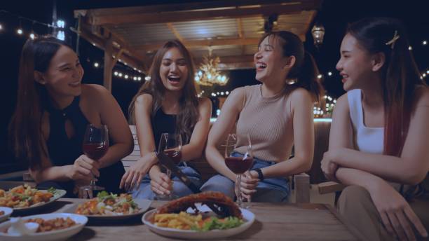 party with best friends. group of cheerful young people enjoying at luxury bar with snacks and drinks. happy female friends celebrating holiday event party at nightclub in the city - concert stock pictures, royalty-free phot