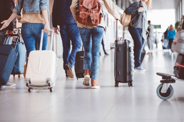 passengers walking in the airport terminal - travel stock pictures, royalty-free photos & images