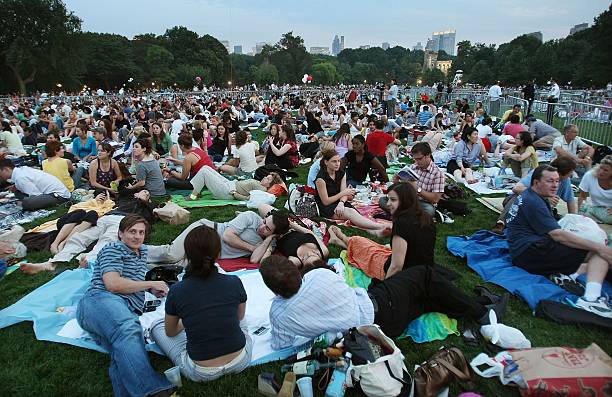 Patrons sit before a free concert in Central Park by the New York Philharmonic July 17, 2007 in New York City. The Philharmonic annually performs a...