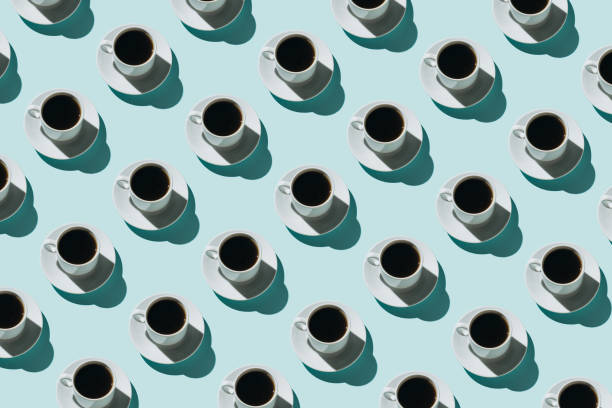 pattern of coffee cups on blue background - coffee stock pictures, royalty-free photos & images