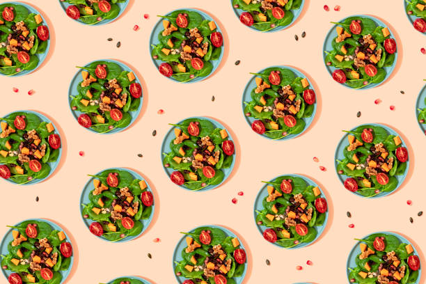 pattern of plates of fresh ready-to-eat vegan salad - food stock illustrations