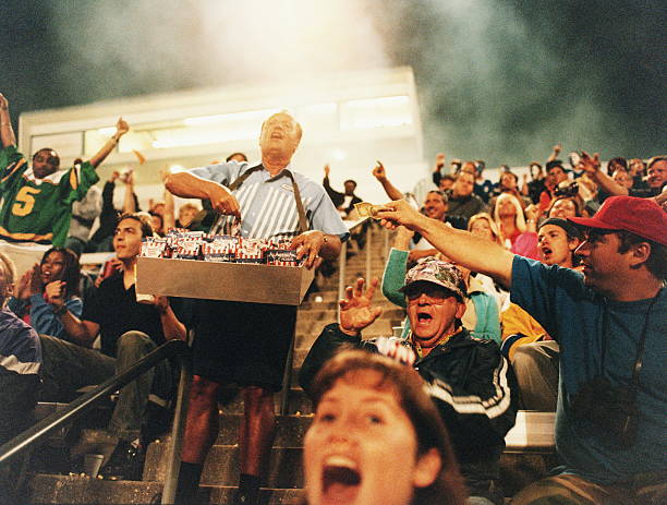 peanut vendor selling in stadium, man holding out money - food stock pictures, royalty-free photos & images