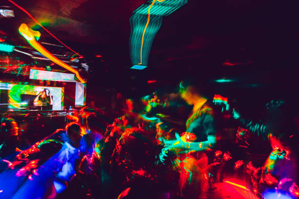people dancing in nightclub - concert stock pictures, royalty-free photos & images