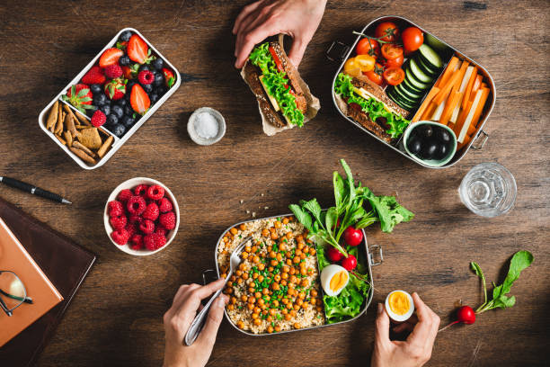 people having balanced diet from lunch boxes - food stock pictures, royalty-free photos & images