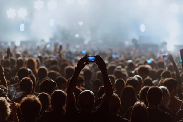 people recording a rock concert with their cell phones - concert stock pictures, royalty-free photos & images