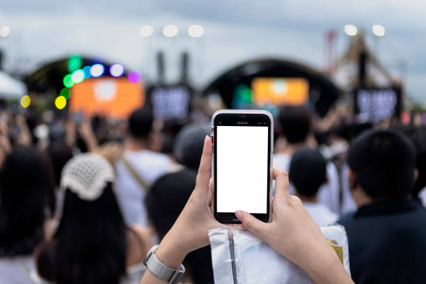 people recording videos with cell phones at music festival - concert stock pictures, royalty-free photos & images