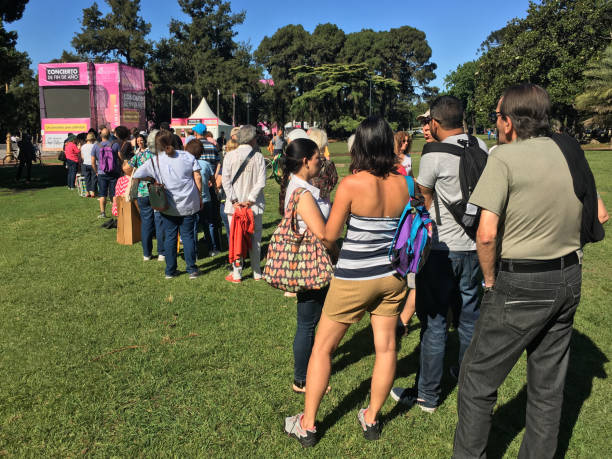 people waiting in line outdoors for public concert - concert stock pictures, royalty-free photos & images