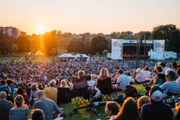 people watching an open air classical music concert at ahuntsic park in montréal - concert stock pictures, royalty-free photos & images