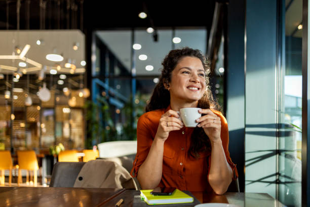 person enjoying coffee in a modern cafe setting. - coffee stockfoto's en -beelden