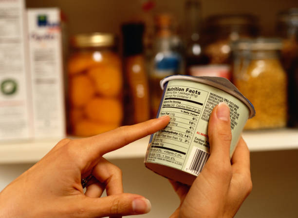 person reading nutrition label on packaged food - food stock pictures, royalty-free photos & images