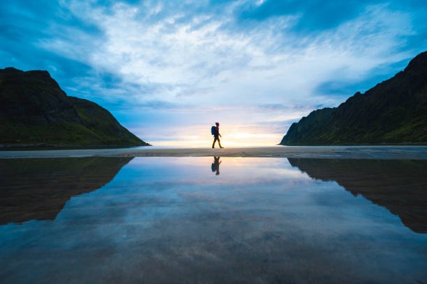person walking on the baech at sunset, senja, norway - travel stock pictures, royalty-free photos & images