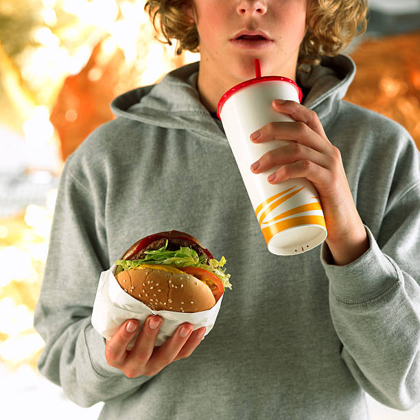 person with fast food - junk food stockfoto's en -beelden