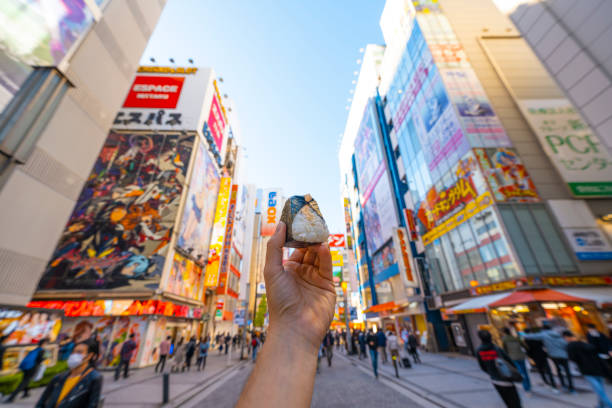personal perspective of person eating onigiri in tokyo, japan - food stock pictures, royalty-free photos & images