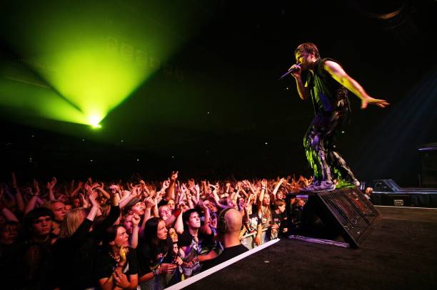 Photo of Bruce DICKINSON and IRON MAIDEN, Bruce Dickinson performing live onstage, standing at front of stage, looking out over cheering, waving fans...