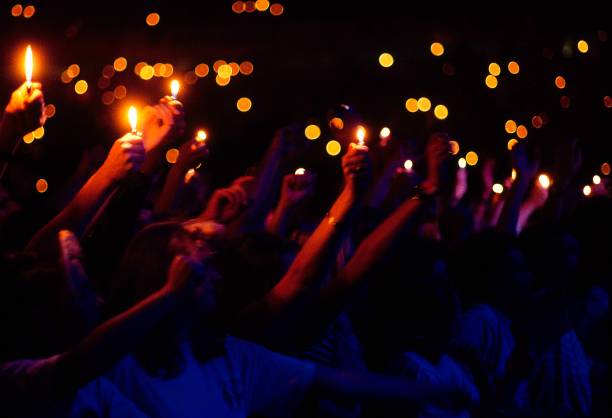 Photo of LIGHTERS and LIGHT SHOWS. Cagarette lights being held in the air at a rock concert in The Netherlands circa 1990.