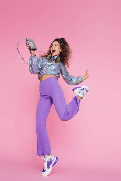 photo of positive girl holding old audio player in her hand and dancing - fashion stock pictures, royalty-free photos & images