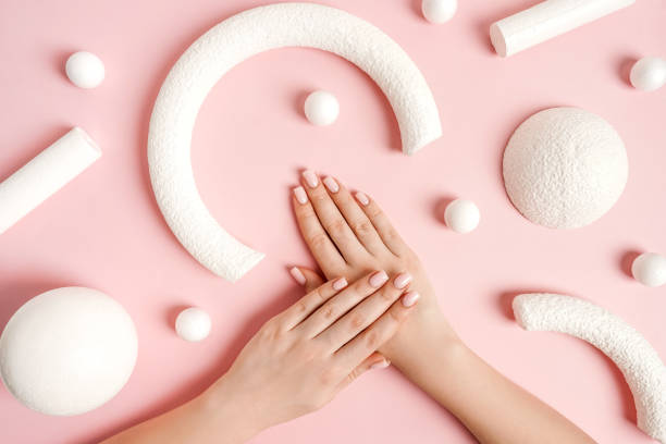 pink manicure and white abstract shapes on pink background, top view. - nails art stock pictures, royalty-free photos & images