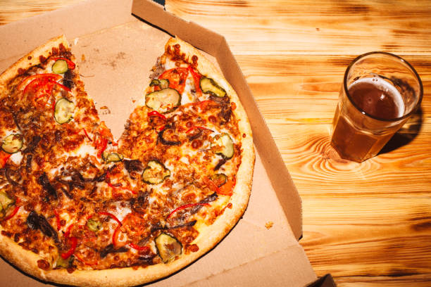 pizza and glass of craft beer on the wooden table - junk food stock pictures, royalty-free photos & images