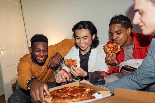pizza at a house party - junk food stock pictures, royalty-free photos & images