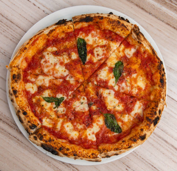 pizza,high angle view of pizza on table - junk food stock pictures, royalty-free photos & images