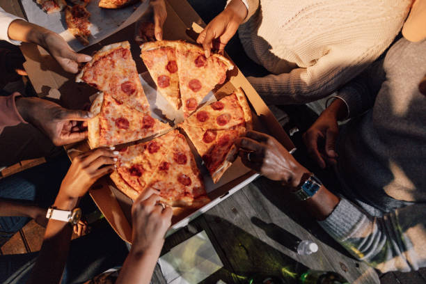 pizza party - junk food stock pictures, royalty-free photos & images