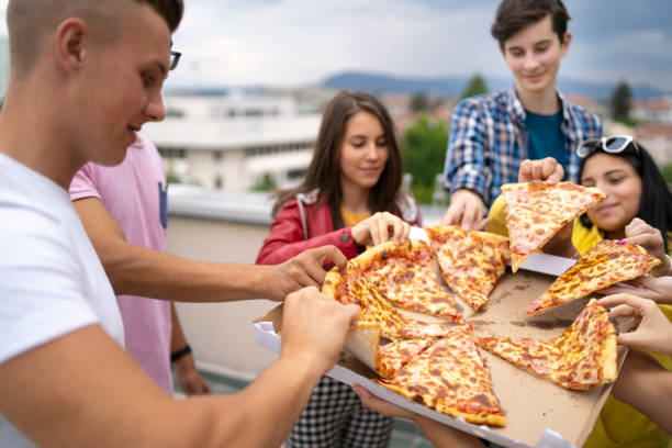 pizza time with friends - junk food stock pictures, royalty-free photos & images