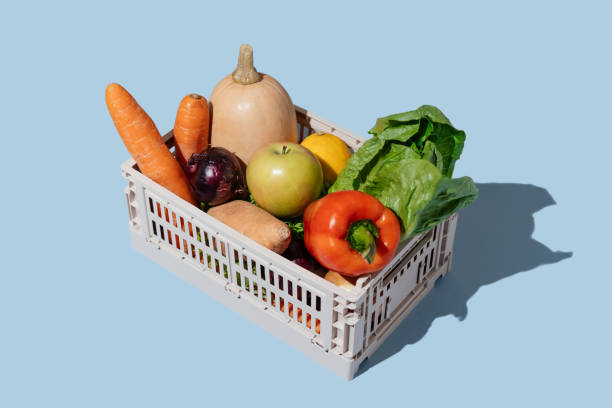 plastic box of organic vegetables and fruits on blue background. grocery subscription boxes. meal kits home delivery. - food stock pictures, royalty-free photos & images