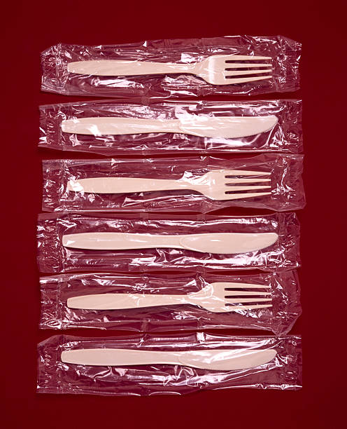 plastic knives and forks in wrappers - junk food stock pictures, royalty-free photos & images