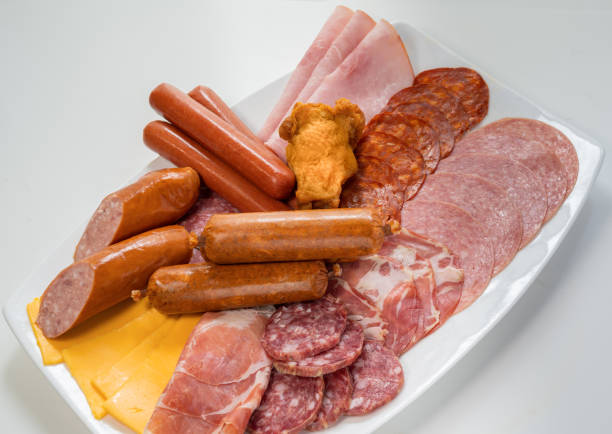 plate filled with unhealthy processed meats and cheese - junk food stock pictures, royalty-free photos & images