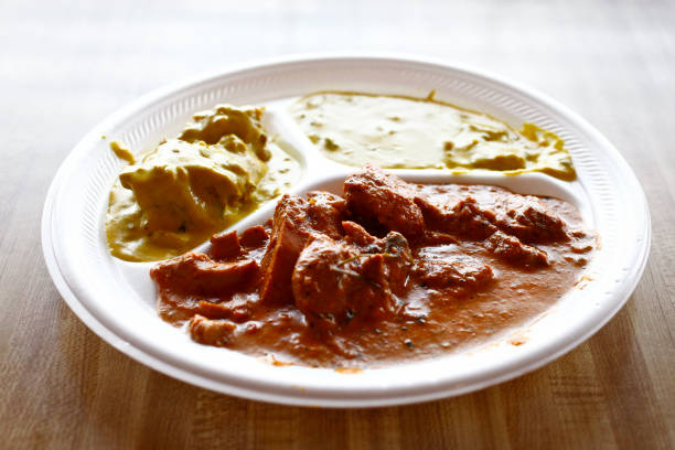 Platters of Indian foods, including Vegetable Curry and Butter Chicken, at Raja Sweets, a fast-food Indian restaurant that celebrated its 25th...