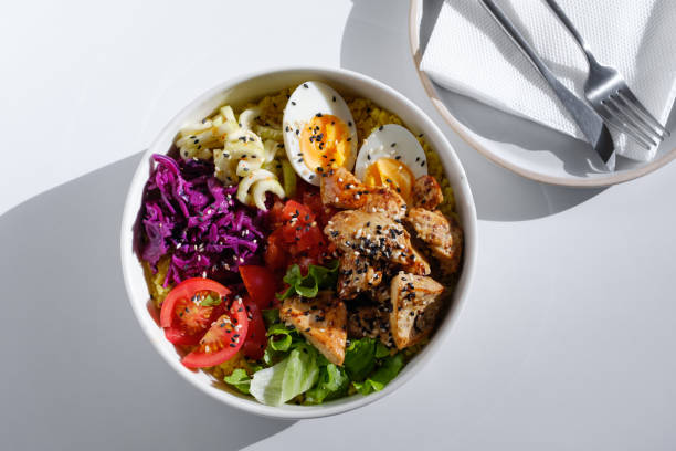 poke, a dish of fresh meat, raw fresh vegetables. enjoy hawaiian cuisine in a restaurant or at a cafe table during the summer holidays on a trip. the concept of healthy eating. a balanced set of proteins, fats and carbohydrat