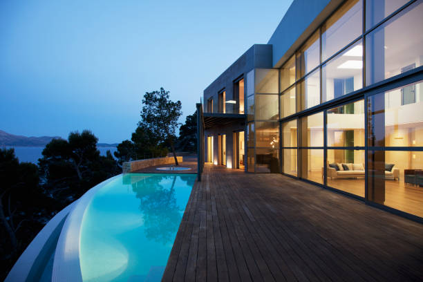 pool outside modern house at twilight - fashion stock pictures, royalty-free photos & images
