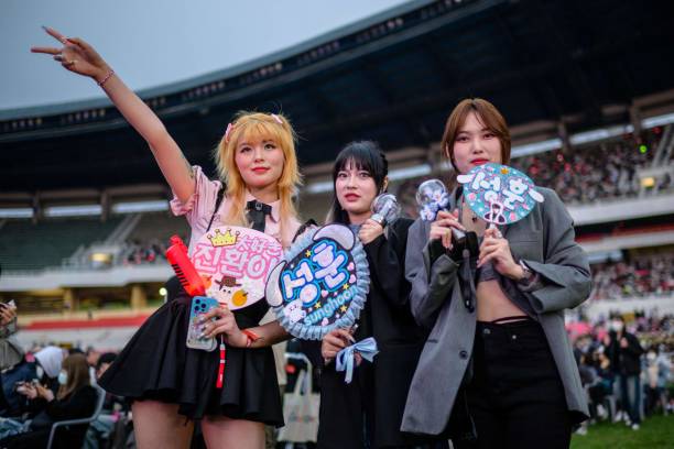 Pop fans pose for a photograph before a K-pop concert as part of the Seoul Festa 2023, at the Jamsil stadium in Seoul, on April 30, 2023.