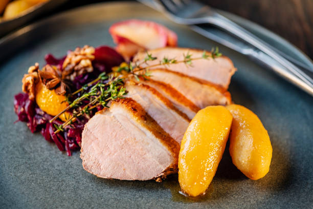 pork loin with red cabbage and potatoes - food stockfoto's en -beelden
