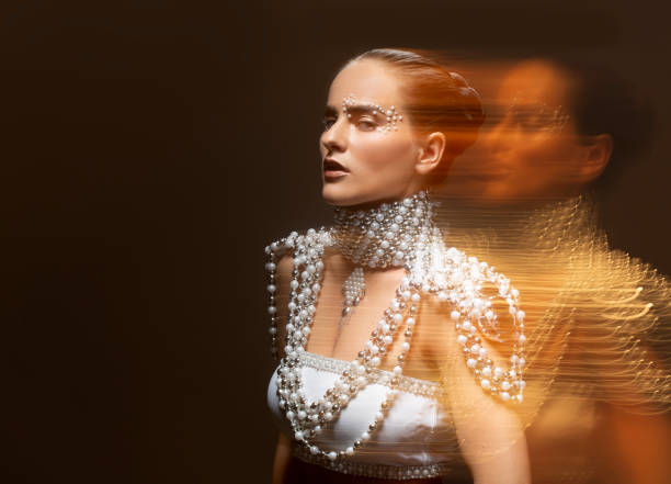 portrait of a beautiful brunette woman wearing pearl jewels - fashion stock pictures, royalty-free photos & images