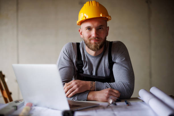 portrait of a confident young man working at construction site - home decoration stock pictures, royalty-free photos & images