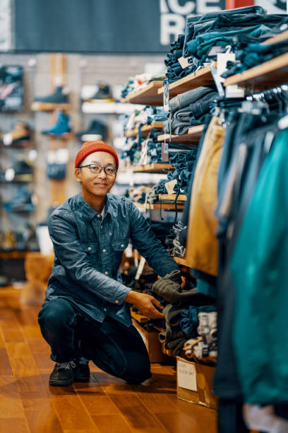 portrait of a mid adult male working in a retail clothing store - fashion stock pictures, royalty-free photos & images
